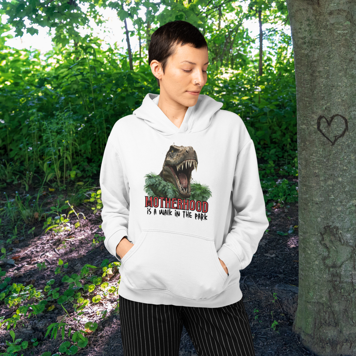 hoodie, dinosaur, motherhood, parenting, family, mom life, cozy wear, humorous design, mother's day, mom gift, soft fabric, light-hearted phrase, casual style, warmth, versatile, comfort, strength, adventure, mom pride, laughter, fashion, quality, durability, motherhood its a walk in the park tee