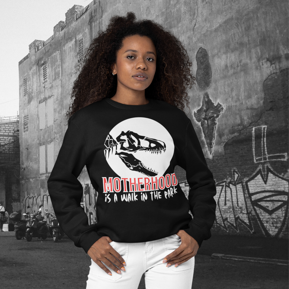sweatshirt, dinosaur, motherhood, parenting, family, mom life, cozy wear, humorous design, mother's day, mom gift, soft fabric, light-hearted phrase, casual style, warmth, versatile, comfort, strength, adventure, mom pride, laughter, fashion, quality, durability, motherhood its a walk in the park tee